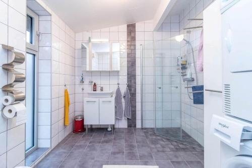 a white bathroom with a sink and a shower at VGO1063-Karlsborg-Silverdalen-1 in Karlsborg