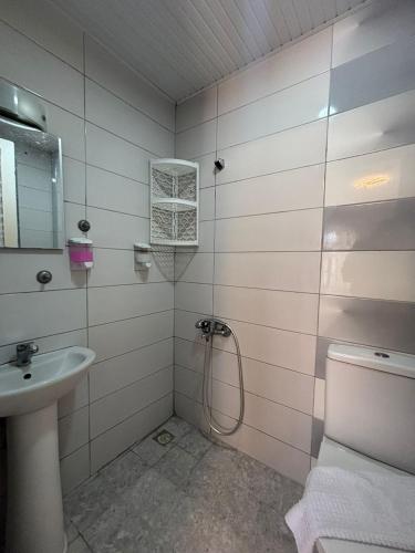 a bathroom with a shower and a sink at Sincer Otel in Kuşadası