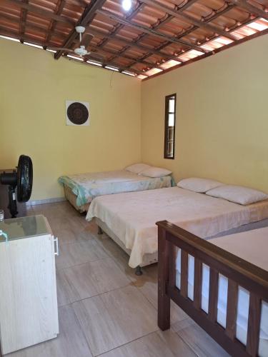 a room with two beds in a room at Encanto na Mata in Mata de Sao Joao