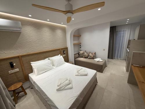 a hotel room with a bed and a couch at Azulic Suites Nikiti in Nikiti