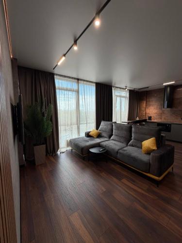 a large living room with a couch and a tv at Studio Loft in Fontanka