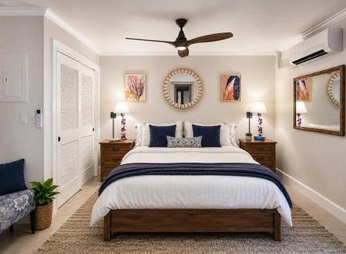 a bedroom with a bed and a ceiling fan at Poipu Beach Condo with AC and Pool in Koloa