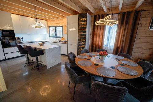 a kitchen and dining room with a table and chairs at Chatička in Veľká Lomnica