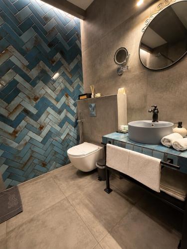 a bathroom with a sink and a toilet and a mirror at Global Home - Aparthotel - No Contact Check In in Mielec
