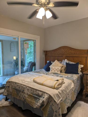 a bedroom with a large bed with a ceiling fan at Country side house with with cozy 3 bedrooms and 2 bath in Minneola