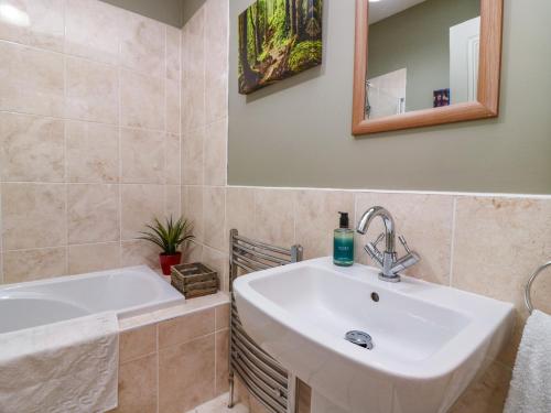a bathroom with a sink and a bath tub at St Kilda in Ballater