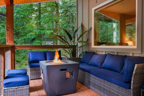 a living room with a couch and a fireplace at Timberline Terrace in Glacier