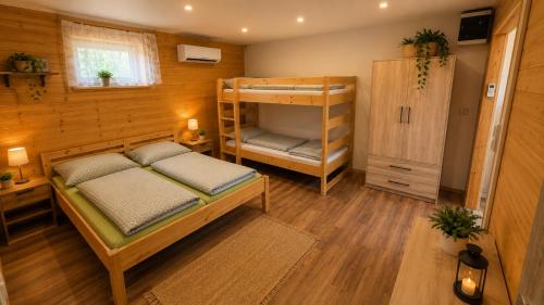 a bedroom with a bunk bed and a bunk room with a ladder at Kemp Srdíčko in Doksy