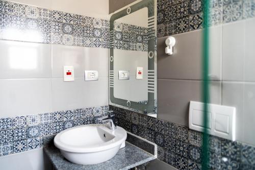 a bathroom with a sink and a mirror at 33A4. Rooftop Studio w Terrace Green Views in Sheikh Zayed
