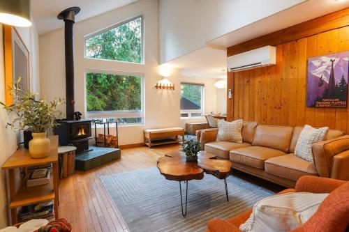 a living room with a couch and a fireplace at Colfax Cabin in Glacier