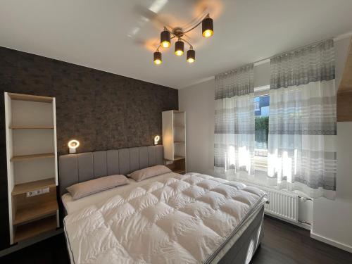 a bedroom with a large bed and a window at Astrid's Appartements in Winterberg