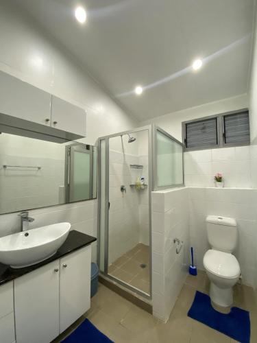 a bathroom with a toilet and a sink and a shower at Muaicolo House in Suva