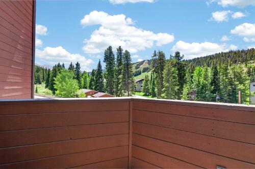 a wooden fence with a view of a mountain at Winter Park Place #18 in Winter Park