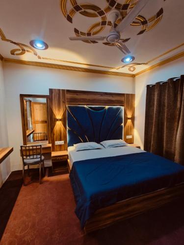 a bedroom with a blue bed and a chandelier at The Sapphire Retreat in Srinagar