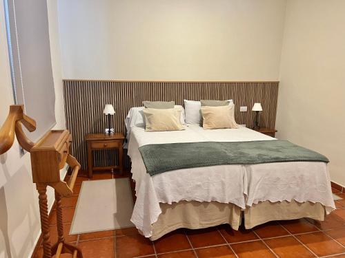 a bedroom with a large bed and two night stands at Finca La Romera in La Orotava
