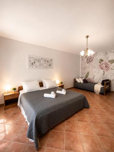 a bedroom with a large bed and a couch at Apartments Marina in Lopar