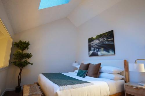 a bedroom with a white bed with pillows at Crystal Creek Retreat in Bellingham