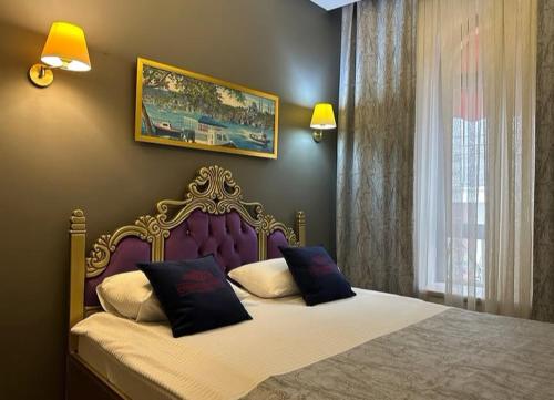 a bedroom with a large bed with two pillows at Ethnica Hotel Old City in Istanbul