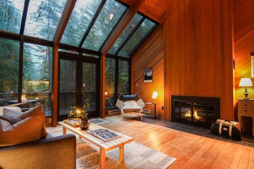 a living room with a fireplace and glass windows at Skywood in Deming
