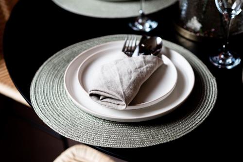 a plate with a fork and a napkin on a table at Town Centre - Elegant Stylish Apartment in Shrewsbury