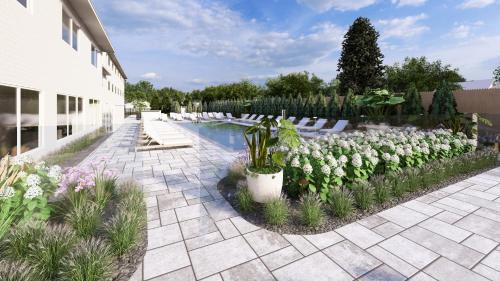 a garden with white flowers and a pool at Pell Hotel JdV by Hyatt in Middletown