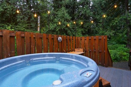 a hot tub in a backyard with a wooden fence at Hearthstone in Deming
