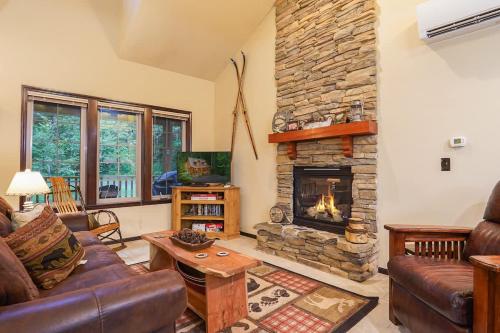a living room with a couch and a stone fireplace at Hearthstone in Deming
