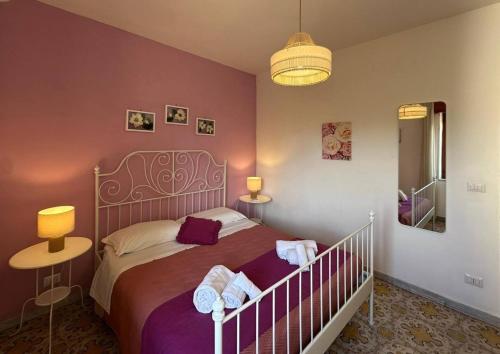 a bedroom with a bed with towels on it at Casa Maccers in Giardini Naxos