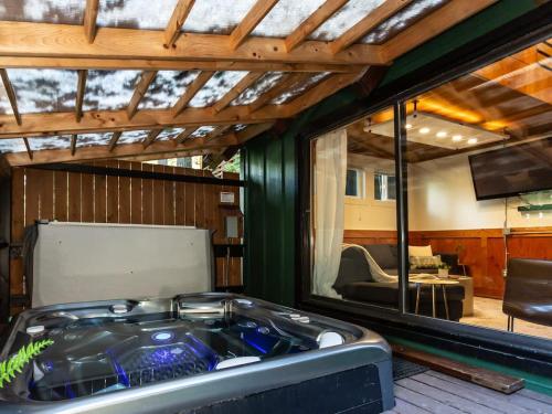 a jacuzzi tub in the middle of a room at Birdhouse Cottage in Glacier