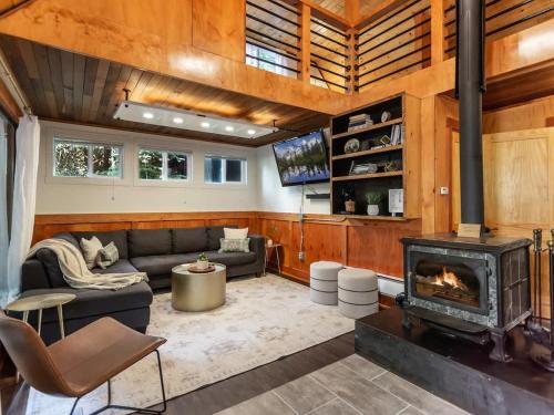 a living room with a couch and a fireplace at Birdhouse Cottage in Glacier