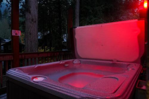 a pink bath tub with a red light in it at Avventura Chalet in Glacier