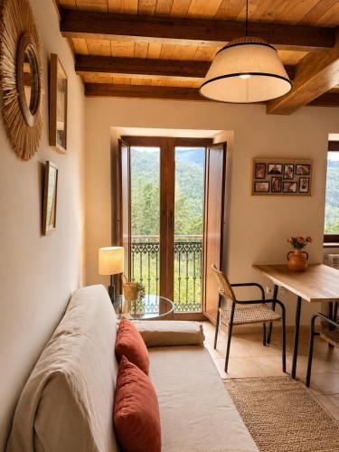 a room with a bed and a table and a window at RURAL PRADO in San Tirso de Abres