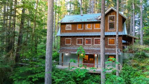 a wooden house in the middle of the forest at The Shuksan in Deming