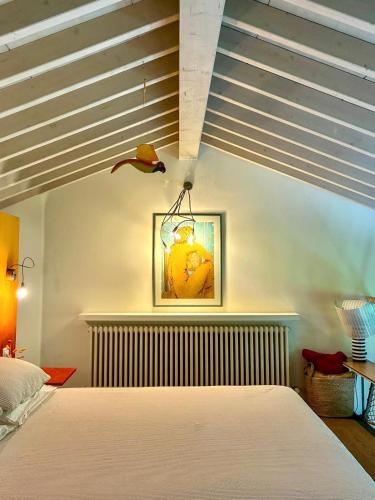 a bedroom with a bed and a painting on the wall at La Casetta del Lago in Lovere