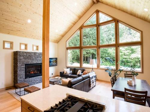 a living room with a couch and a fireplace at Church Mountain View Chalet in Glacier