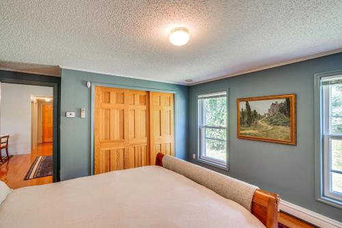 a bedroom with a bed and two windows at Hudson Valley Multi-Unit Escape: Secluded + Scenic in Claverack