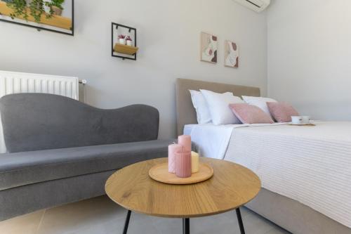a living room with a couch and a table at Rania's Seaside Nest- Steps from the Beach in Kiaton