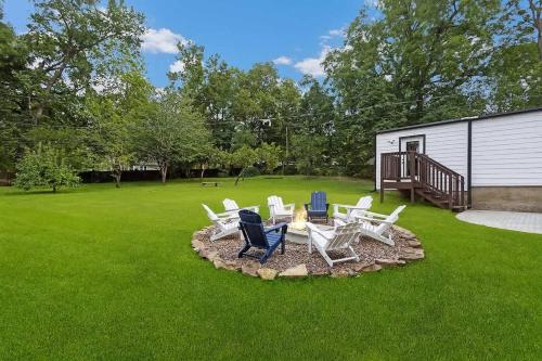 a group of chairs and a table in a yard at Stylish KC FarmhouseHugeFencedYard in Merriam