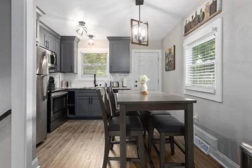 a kitchen with a table and chairs in a kitchen at Olathe corporate retreat in Olathe