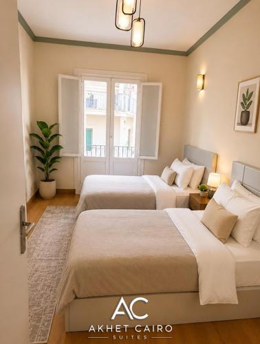 a bedroom with two beds and a window at Akhet Cairo Suites in Cairo