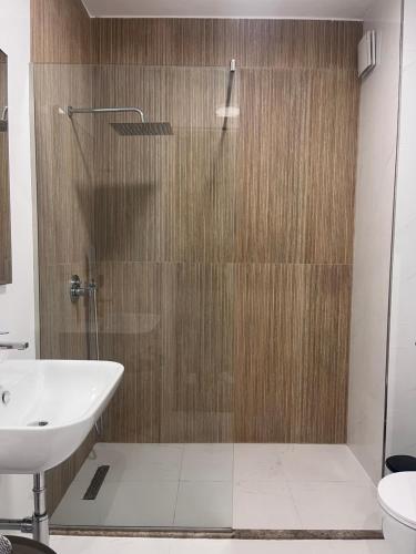 a bathroom with a shower and a sink at The Touch of the Sea in Durrës