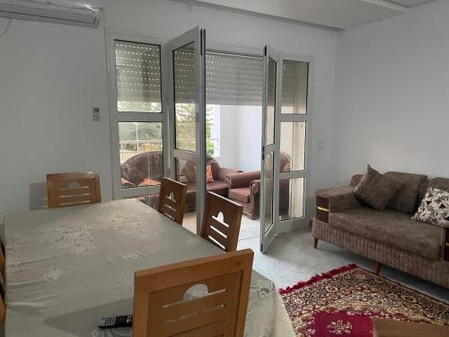 a living room with a couch and a table at Casa Cómoda in Nabeul