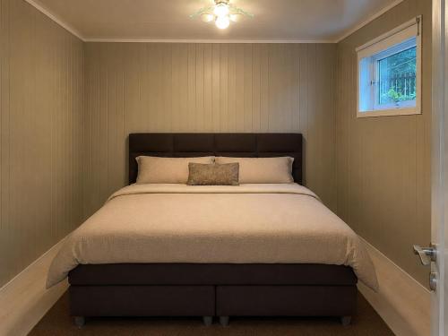 a bedroom with a large bed with a pillow on it at Best place to live in Trondheim