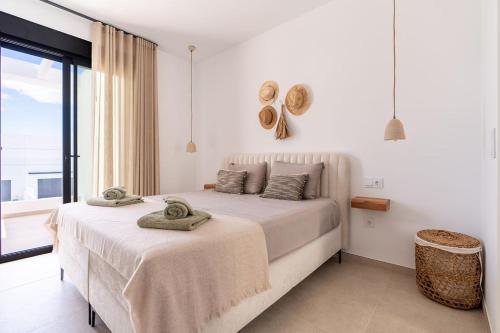 a bedroom with a large bed with towels on it at Luxe zuiderse villa in Dolores