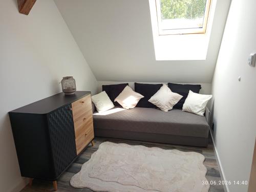 a couch in a small room with a window at Miła Przystań in Debrzno