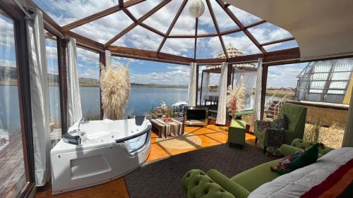 a living room with a large glass dome with a view of the water at TiticacaMarkaLodge in Puno