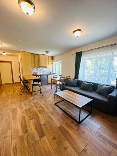 a living room with a couch and a table at Rožu namu apartamenti 6 in Kuldīga