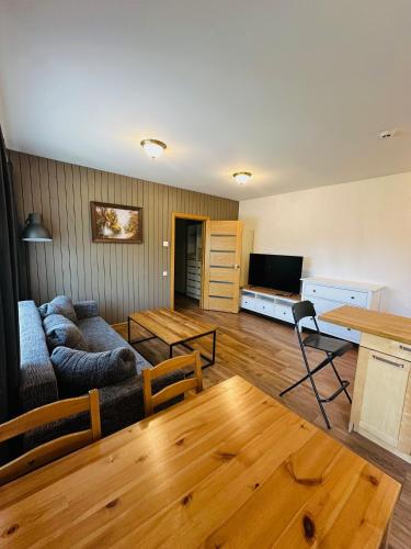 a living room with a couch and a table at Rožu namu apartamenti 6 in Kuldīga