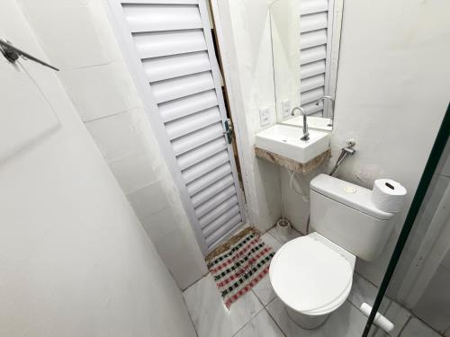 a small bathroom with a toilet and a sink at Mini Ap no derby com Garagem in Sobral