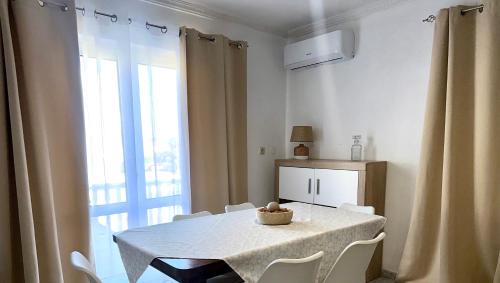 a white table and chairs in a room with a window at Sweet Home in Miranda do Douro